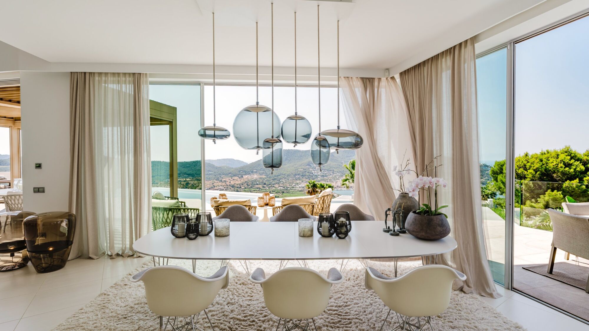 A bright dining room with glass pendants