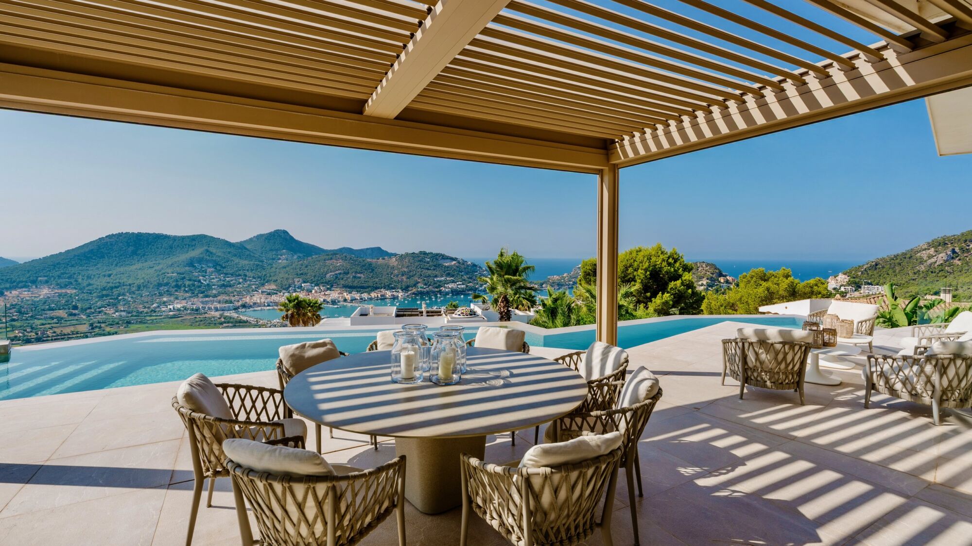 Dining under the pergola at Casa Sunshine, the bay behind